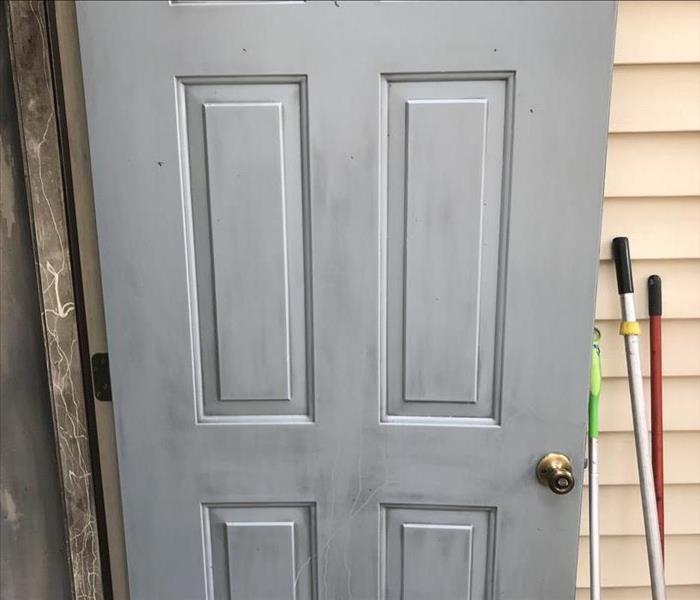 Light gray door with dark patches