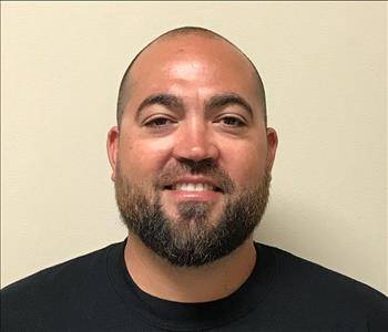Headshot of man wearing SERVPRO uniform in front of neutral background
