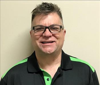Headshot of smiling man wearing glasses and SERVPRO uniform