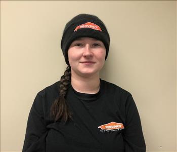 Headshot of smiling woman wearing a black SERVPRO t-shirt in front of a gray background