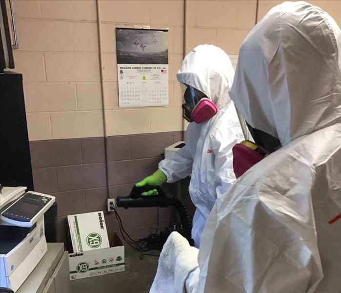 Two SERVPRO employees in PPE standing in an office