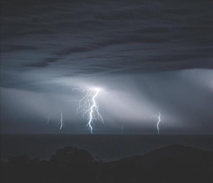 Multiple lightning strikes in a dark, stormy area