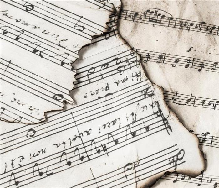 Sheet music with fire-damaged edges